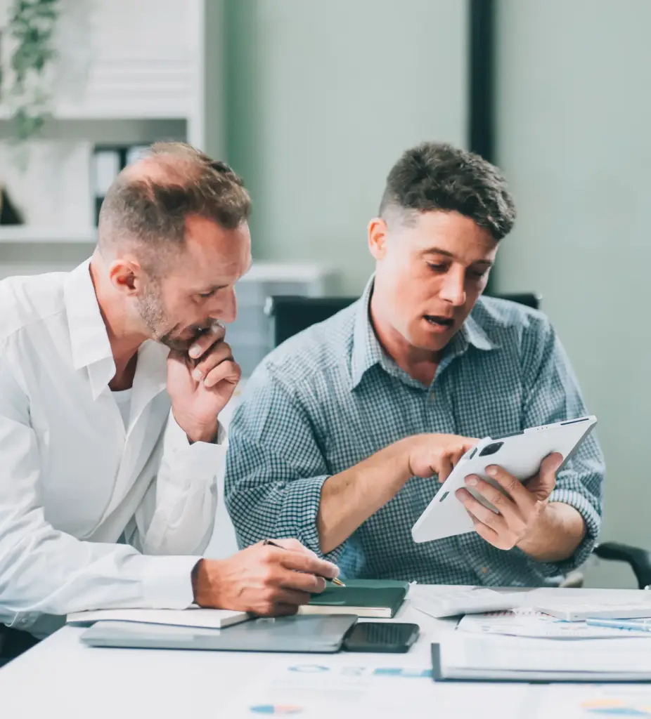 Two accountants reviewing a client's financial reports