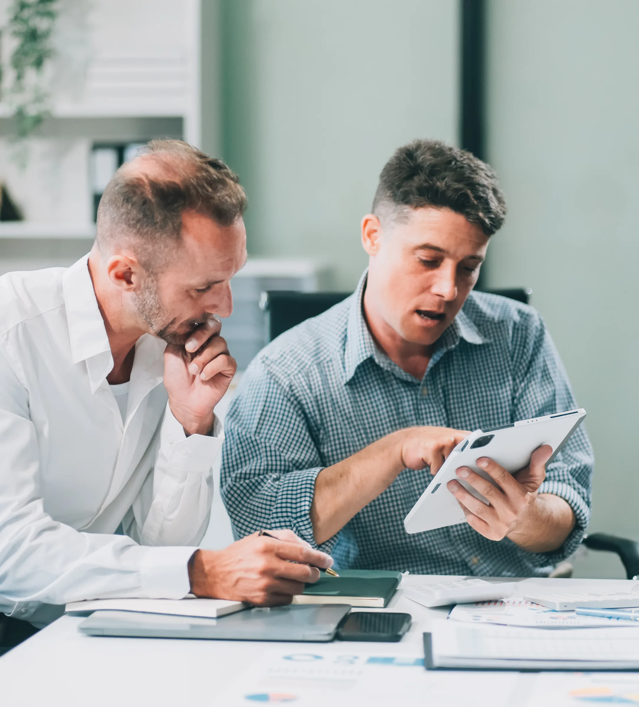 Accountants reviewing financial reports and charts with a client