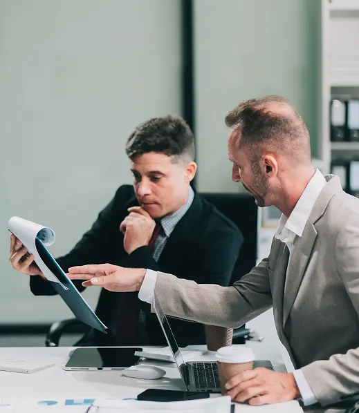 Accountants reviewing financial reports and charts with a client